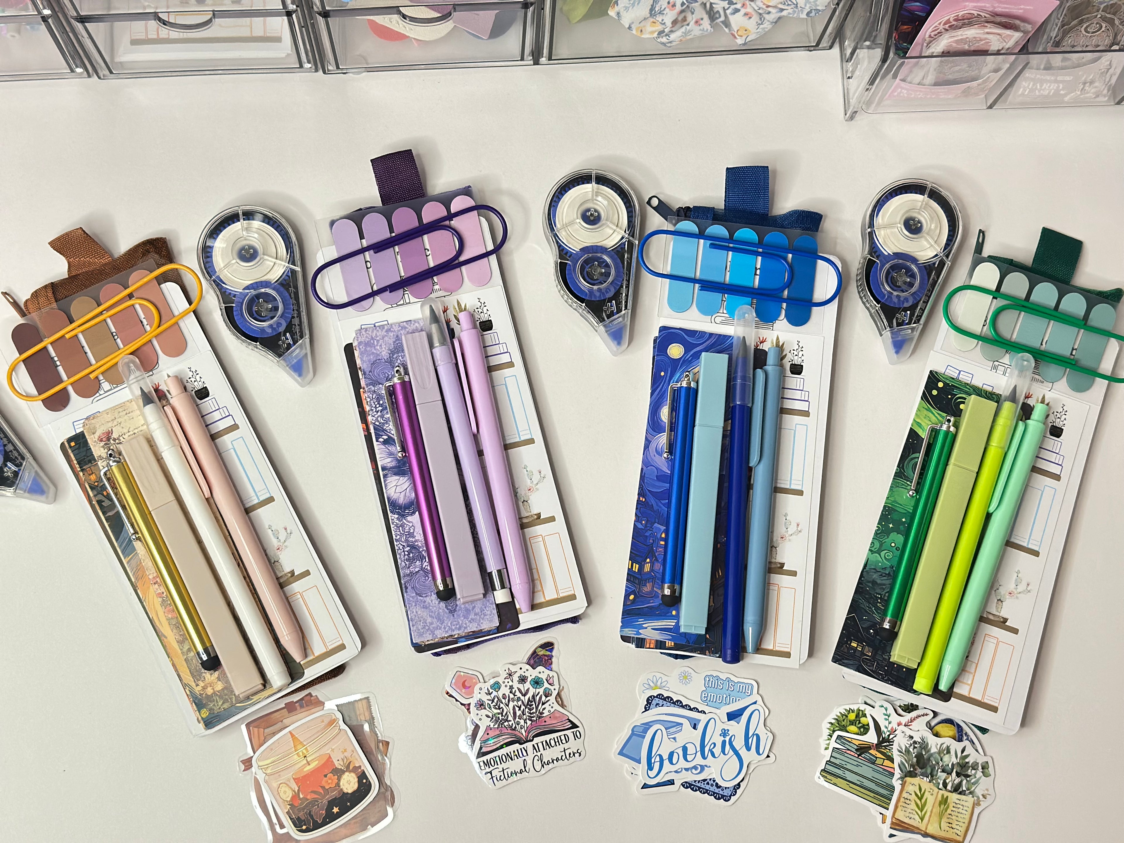 Collection of stationery items including pens, markers, and stickers on a white surface.